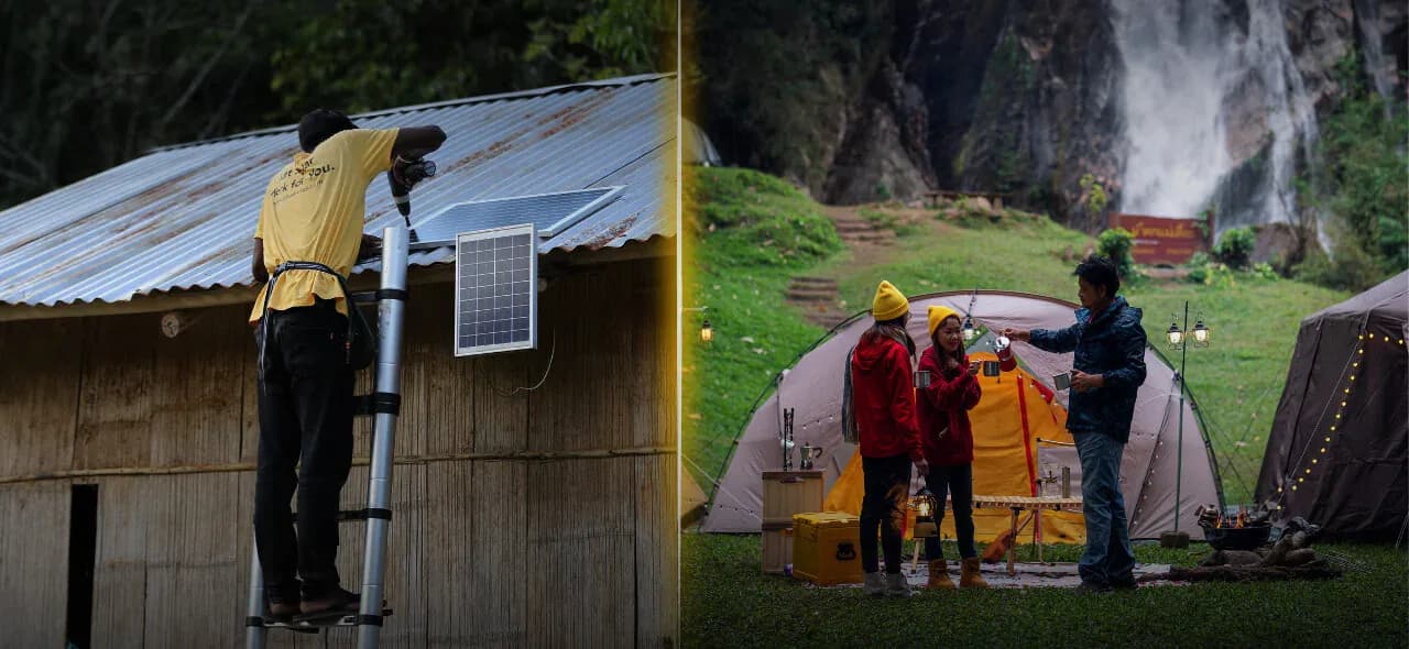 A solar installer working on a rooftop beside a lit campsite at night